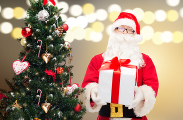 Image showing santa claus with gift box at christmas tree