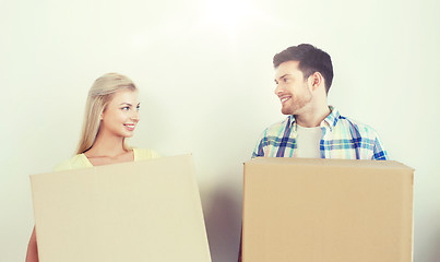 Image showing smiling couple with big boxes moving to new home