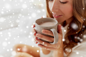 Image showing close up of happy woman with cup of cocoa at home