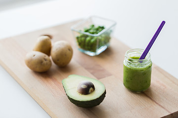 Image showing jar with puree or baby food on wooden board