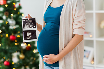 Image showing pregnant woman with ultrasound images at christmas