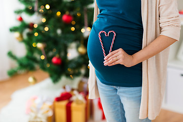 Image showing close up of pregnant woman with heart at christmas