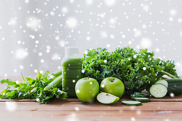 Image showing close up of bottle with green juice and vegetables