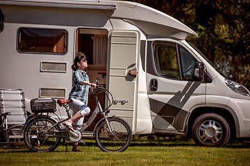 Image showing Woman on electric bike resting at the campsite VR Caravan car Va