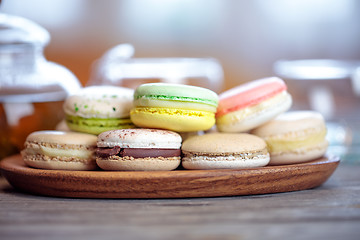 Image showing Close-up of colorful macaron (macaroon) on the table with hot te