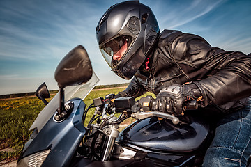 Image showing Biker racing on the road