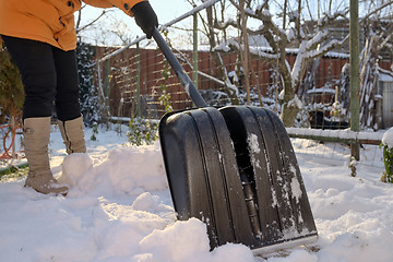 Image showing Woman Shoveling her garden