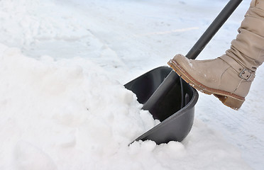 Image showing Woman Shoveling snow on street