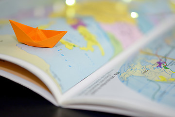 Image showing Paper boat on a atlas book