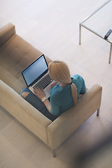 Image showing Young woman using laptop at home