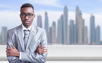 Image showing Young black businessman in front of the big city