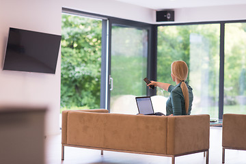 Image showing Young woman using laptop at home