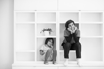 Image showing young boys posing on a shelf