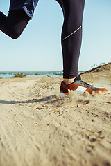 Image showing Running sport. Man runner sprinting outdoor in scenic nature. Fit muscular male athlete training trail running for marathon run.