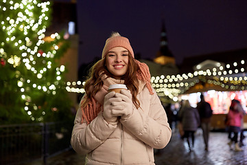 Image showing happy young woman with coffee at christmas market