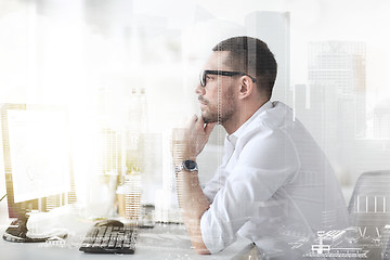 Image showing businessman in glasses sitting at office computer