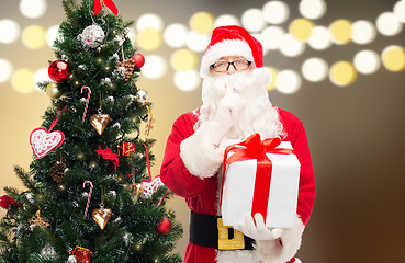 Image showing santa claus with gift box at christmas tree