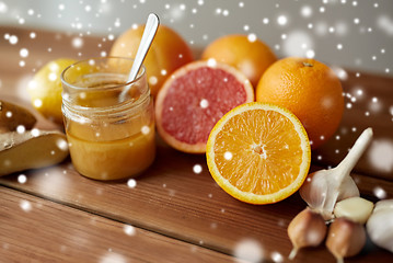 Image showing honey, citrus fruits, ginger and garlic on wood