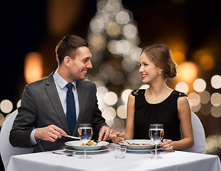 Image showing smiling couple eating at christmas restaurant