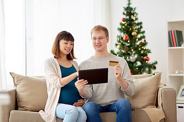 Image showing man and pregnant wife shopping online at christmas