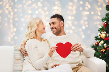 Image showing happy couple with red heart at christmas