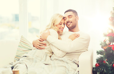 Image showing happy couple at home with christmas tree