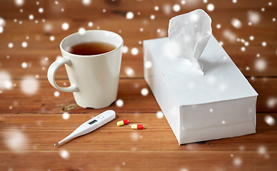 Image showing cup of tea, paper wipes and thermometer with pills