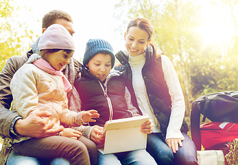 Image showing happy family with tablet pc and backpacks at camp