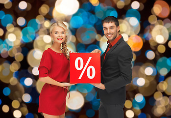 Image showing couple with discount sign over christmas lights