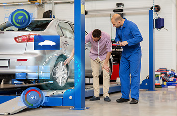 Image showing auto mechanic with clipboard and man at car shop