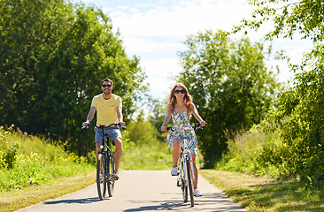 Image showing happy young couple riding bicycles in summer