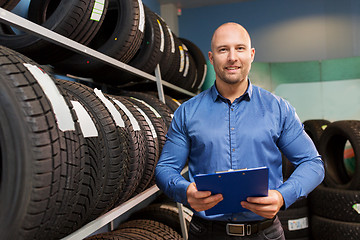 Image showing auto business owner and wheel tires at car service