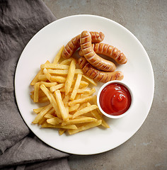 Image showing fried potatoes and sausages