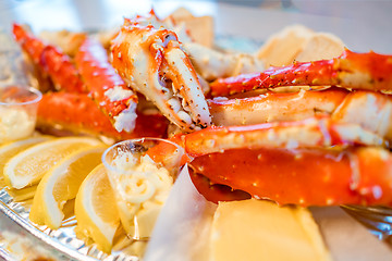 Image showing Red king crab legs with fresh lemon slices