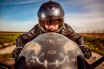 Image showing Biker racing on the road