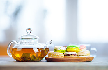 Image showing Close-up of colorful macaron (macaroon) on the table with hot te