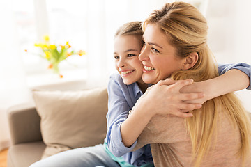 Image showing happy smiling family hugging on sofa at home