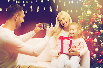 Image showing man photographing his family with christmas gift