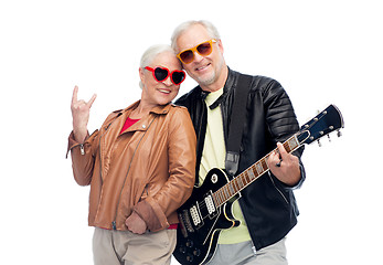 Image showing senior couple with guitar showing rock hand sign