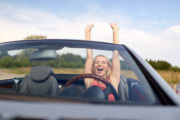 Image showing happy young woman in convertible car