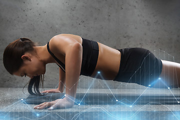 Image showing woman doing push-ups in gym