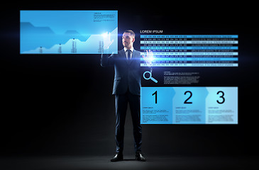 Image showing businessman with stock charts on virtual screens