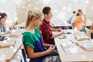 Image showing student girl with smartphone texting at school