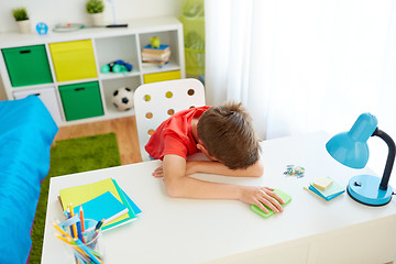 Image showing tired or sad student boy with smartphone at home