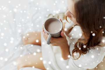 Image showing close up of woman with cocoa cup in bed at home