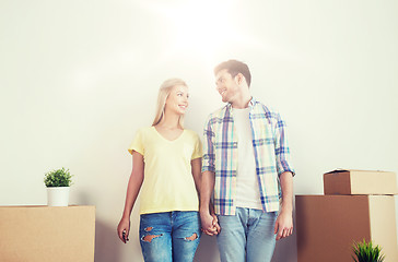 Image showing smiling couple with big boxes moving to new home