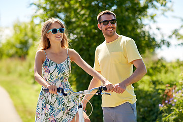 Image showing happy couple with bicycle at country