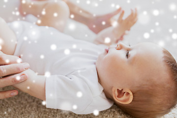 Image showing close up of happy little baby and mother hands