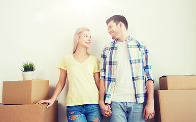 Image showing smiling couple with big boxes moving to new home