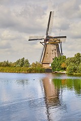 Image showing Windmill beside a canal